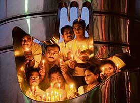 Members of the Anti-Terrorist Front hold a candle-light protest against the Mumbai blasts at Sukhna Lake on Tuesday