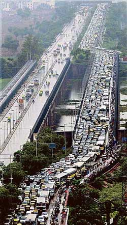 Traffic comes to a standstill after a heavy downpour created waterlogging at the ITO crossing in New Delhi on Tuesday. 