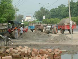 Tractor-trolleys carrying sand parked on the Amritsar-Wagah road near Guru Nanak Dev University