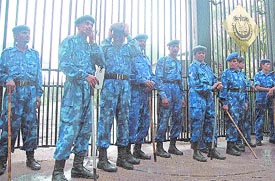 RAF personnel stand guard at Jamia Millia Islamia University in the Capital after the outbreak of violence on the campus on Tuesday