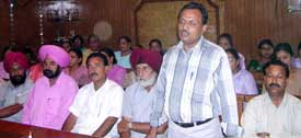 Mr Amrit Pal, president of the Private Aided School Teachers Association, Sangrur, explains problems faced by teachers due to non-payment of salaries at Ahmedgarh on Wednesday