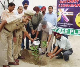 Mr Ashok Kumar Gupta, Deputy Commissioner, Ludhiana, waters a sapling in the Central Jail of Ludhiana on Wednesday