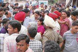 Workers of the SR Industries on Barwala-Dera Bassi road protest against the retrenchment of staff at Dera Bassi