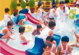 Students of New India School, Sector 15, Panchkula, celebrate swimming day with a splash in the pool to get relief from the scorching sun