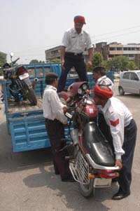 Traffic police personnel impounding motorcycles parked in the District
