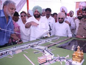 Mr K.S. Kang, Commissioner, Municipal Corporation, Amritsar, shows a model of @@the Rs 173-crore elevated road to the Golden Temple to Chief Minister @@Capt Amarinder Singh in Amritsar on Thursday.
