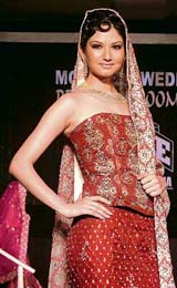 A model presents a wedding outfit created by Pakistani designer at a joint fashion show of Indian and Pakistani designers in New Delhi