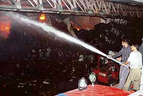 Firemen try to extinguish a fire which broke out at Winsome Yarns on the Barwala-Dera Bassi road on Thursday night