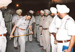Mr Parag Jain, DIG, checks the strength of a cops stick at Jalandhar bypass chowk around 1.30 am on Friday.