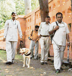 A Delhi police dog squad inspects Parliament House in New Delhi on Friday. The monsoon session begins on Monday.