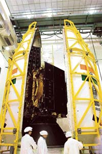 The INSAT-4C satellite being integrated into the GSLVs payload fairing (nose cone)
