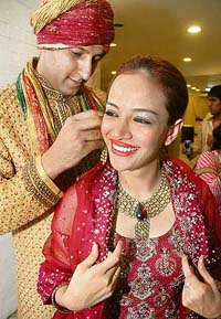 Pakistani models Mohammad Ali and Sara get ready for the inauguration of the Bride & Groom International Jewellery Exhibition in New Delhi