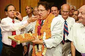 Dr KN Pathak, outgoing Vice-Chancellor, congratulates Dr Ranbir Chander Sobti, Professor of Biotechnology, with sweets after handing over charge to the new VC in Chandigarh on Saturday