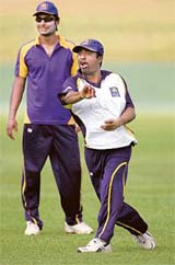Sri Lankas Muttiah Muralitharan (right) and Kumar Sangakkara attend a practice session in Colombo on Saturday. Sri Lanka will play two Tests against visiting South Africa.
