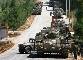 Israeli military vehicles assemble near the village of Avivim, at the Israel-Lebanon border on Saturday.