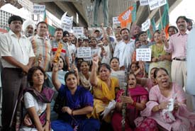 BJP activists protest against rising prices at Clock Tower, Ludhiana, on Monday