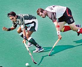 Germanys Niklas Meinert battles for the ball with Pakistans Adnan Zakir during a Champions trophy match in Terrassa on Sunday. The match ended in a 3-3 draw