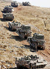 An Israeli army convoy of vehicles moves into Lebanon from near the Israeli town of Avivim, along the Lebanese border, on Monday.
