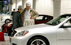Visitors look at Nissan Fuga at Nissan Motor's headquarters in Tokyo