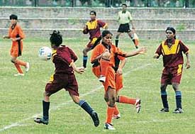 Orissa and Haryana players vying for the ball during the semifinal tie of the Under-17 Football Meet held at the Sector 17 Football Stadium, Chandigarh, on Tuesday