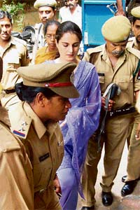 Underworld don Abu Salems girlfriend Monica Bedi being escorted by police personnel as she arrives to appear in a court in Hyderabad