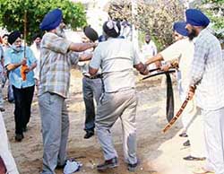 Members of the SGPC task force attack a leader of Akhand Kirtani Jatha at Gurdwara Dukhniwaran Sahib in Patiala where a meeting of SGPC executive committee was held on Tuesday. 