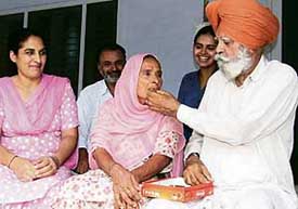 Avneets grandparents offer sweets to each other at their Bathinda residence