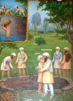 A painting depicts Bhai Manjh, follower of Guru Arjan Dev, who tumbled into a well but saved the wood that he was carrying for Guru ka langar.