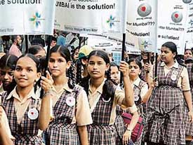 Schoolchildren take out a rally in memory of people who lost their lives last years deluge in Mumbai on Wednesday.
