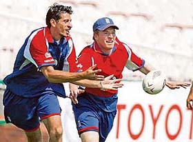 Englands Sajid Mahmood and Jamie Dalrymple compete for a rugby ball during a practice session at the Old Trafford cricket ground in Manchester
