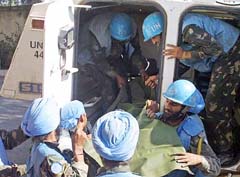 United Nations soilders from India carry the body of a UN observer who was killed during Israeli airstrike on Khiam village in Lebanon