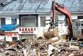 A bulldozer crushes the Sara-Sahara shopping complex, allegedly owned by underworld don Dawood Ibrahim, during a demolition drive by the Municipal Corporation of Greater Mumbai in Mumbai