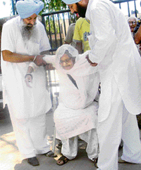 An old woman being taken to a polling booth in Mohali on Sunday.