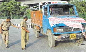 Police officials inspecting a vehicle which injured seven persons near ISBT in the Capital on Sunday.