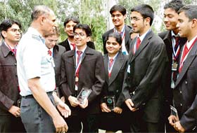 The Chairman of the Chandigarh branch of the Aeronautical Society of India, Air Cmde R K Srivastava, interacts with students of Apeejay School, Jalandhar, who won the international space settlement design competition at Houston, in Chandigarh