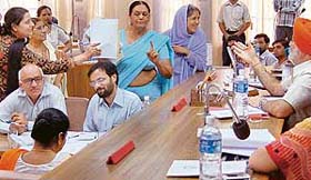 MC councillors argue with the Mayor, Mr Surinder Singh, during proceedings of the MC House meeting in Chandigarh