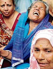 Wailing relatives of the family of seven who were found dead at their residence in Delhi on Monday morning.