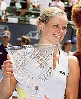 Belgiums Kim Clijsters holds the trophy after beating Switzerlands Patty Schnyder in the final of the Bank of the West tennis tournament in Stanford, California, on Sunday. Clijsters won 6-4, 6-2.