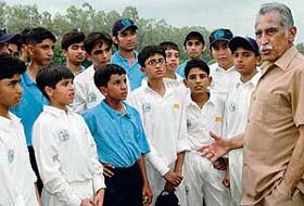 Mr Cecil Chaudhary, Principal of St Anthonys High School, Lahore, gives tips to his cricket team during a match against the team of St Johns School in Sector 26