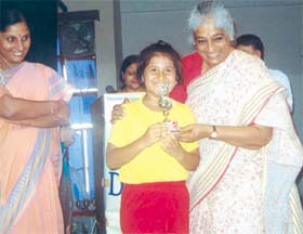 Noted writer Dr Varsha Das gives away a prize to one of the winners in an arithmetic competition.
