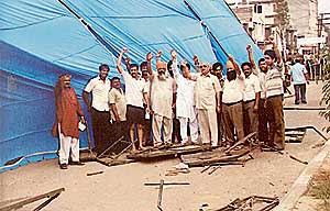 BJP workers led by former Deputy Speaker Satpal Gosain protest against the demolition of their stage allegedly by Congress workers on Monday night.