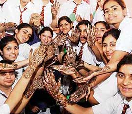 Students of Kundan Vidya Mandir participate in a mehndi competition on the occasion of Teej festival in Ludhiana.