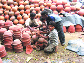 Children help make and sell pottery in Phagwara.