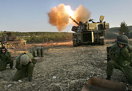 Israeli soldiers cover their ears as a mobile artillery piece fires into Lebanon on Thursday at an Israeli military position located along the Lebanese-Israeli border. Nearly 10,000 Israeli ground troops were battling Hezbollah fighters around some dozen villages in south Lebanon, army radio reported.