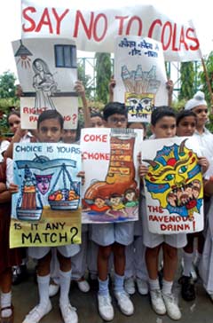 Children hold placards during a protest against soft drinks in Amritsar