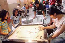 Vishakha (right) plays a shot against Bhavya Dang during the XVI Chandigarh State Carrom Championship at St. Stephen School, Sector 45, Chandigarh, on Sunday.