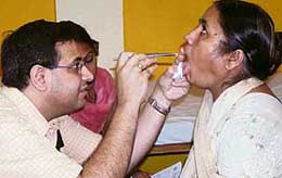 A doctor examines a patient during a free consultation camp on cancer treatment at Grecian Hospital, Mohali, on Sunday. 