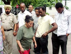 Nigerian nationals and a woman, who were arrested by the Punjab and Delhi Police in a cheating case, being brought to the Parliament police station in New Delhi