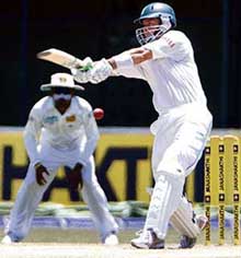 South Africas Herschelle Gibbs plays a shot as Sri Lankan captain Mahela Jayawardene looks on during the third day of the second Test in Colombo on Sunday.