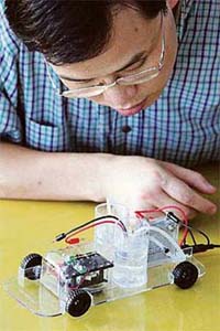 Chief Executive Officer and co-founder of Horizon Fuel Cell Technologies George Gu displays a version of the H-racer toy car that allows user to view the technology inside the model at the companys workshop in Shanghai on Monday.